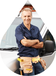 John G. Plumbing Inc. plumber smiling near truck